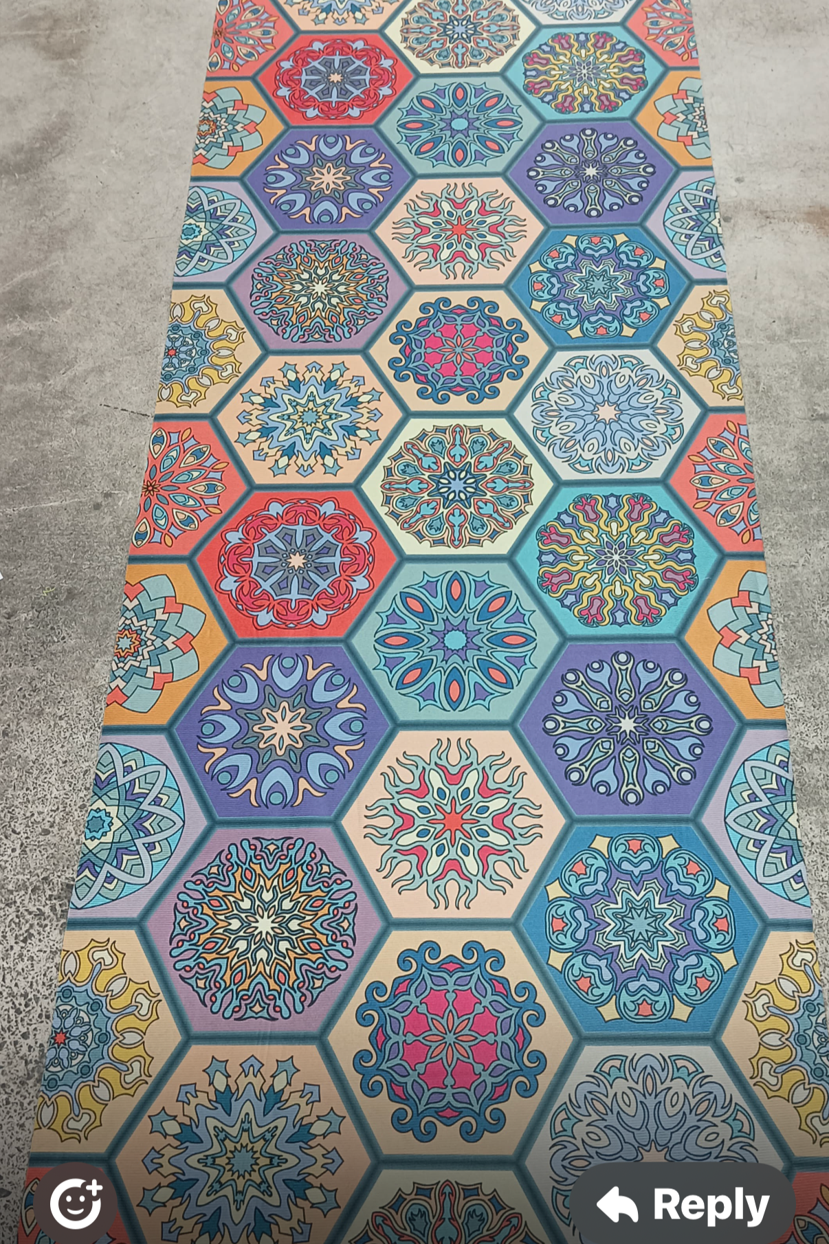 Colorful hexagonal patterned rug on a concrete floor
